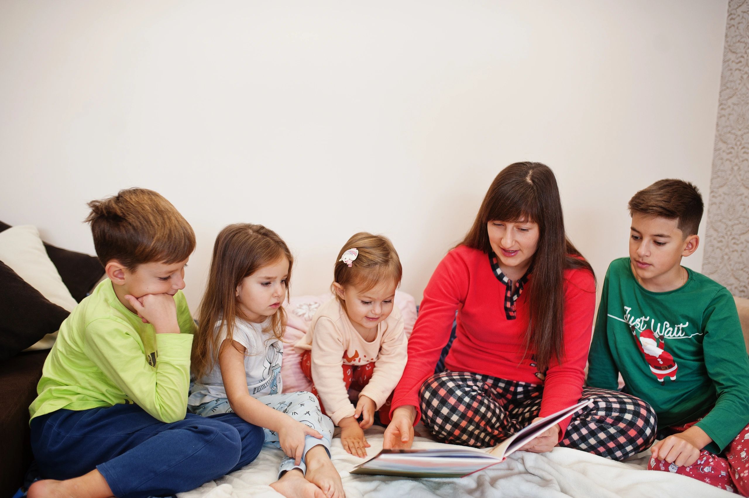 Family reading together in bed