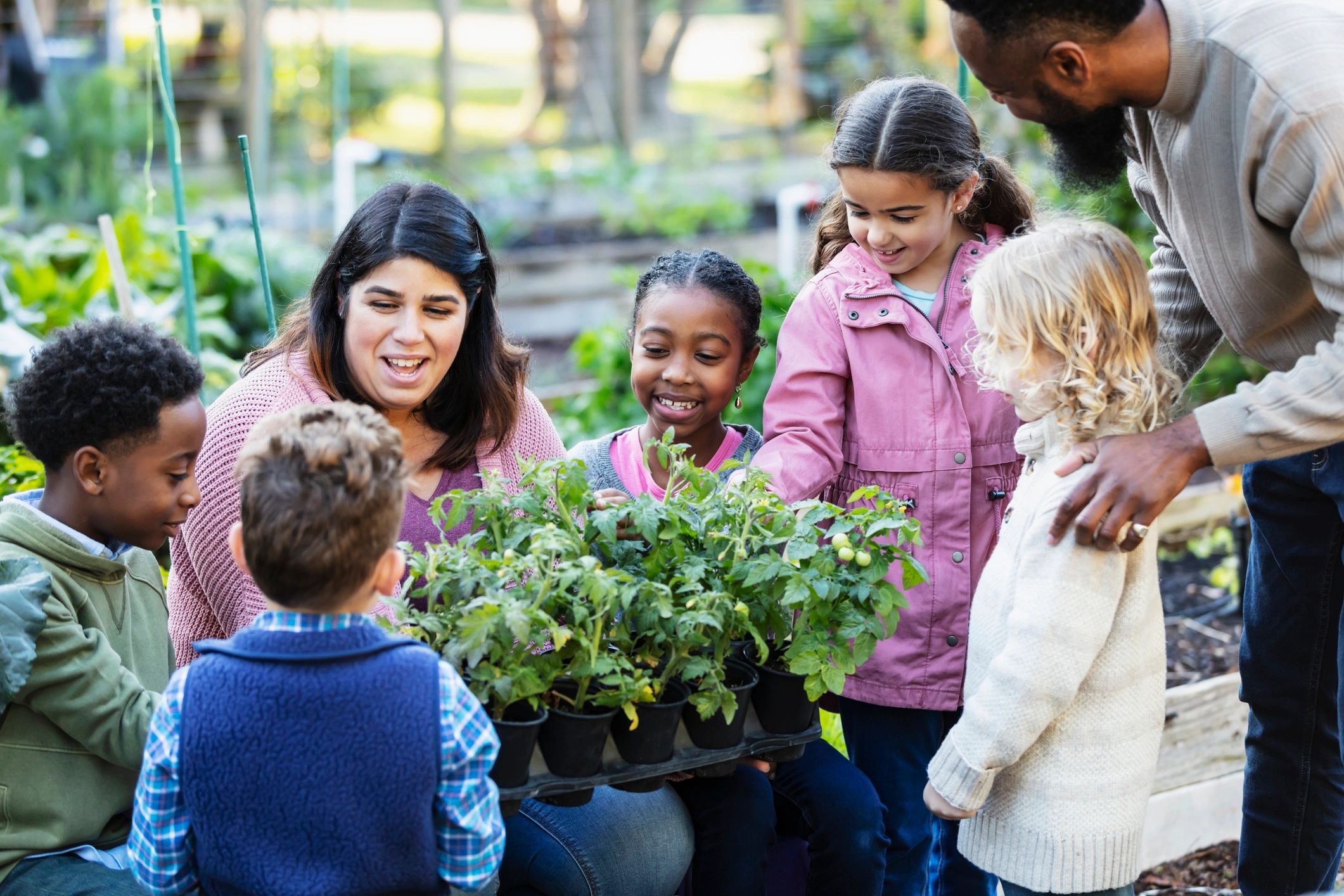 Children learning together outdoors in a warm community setting