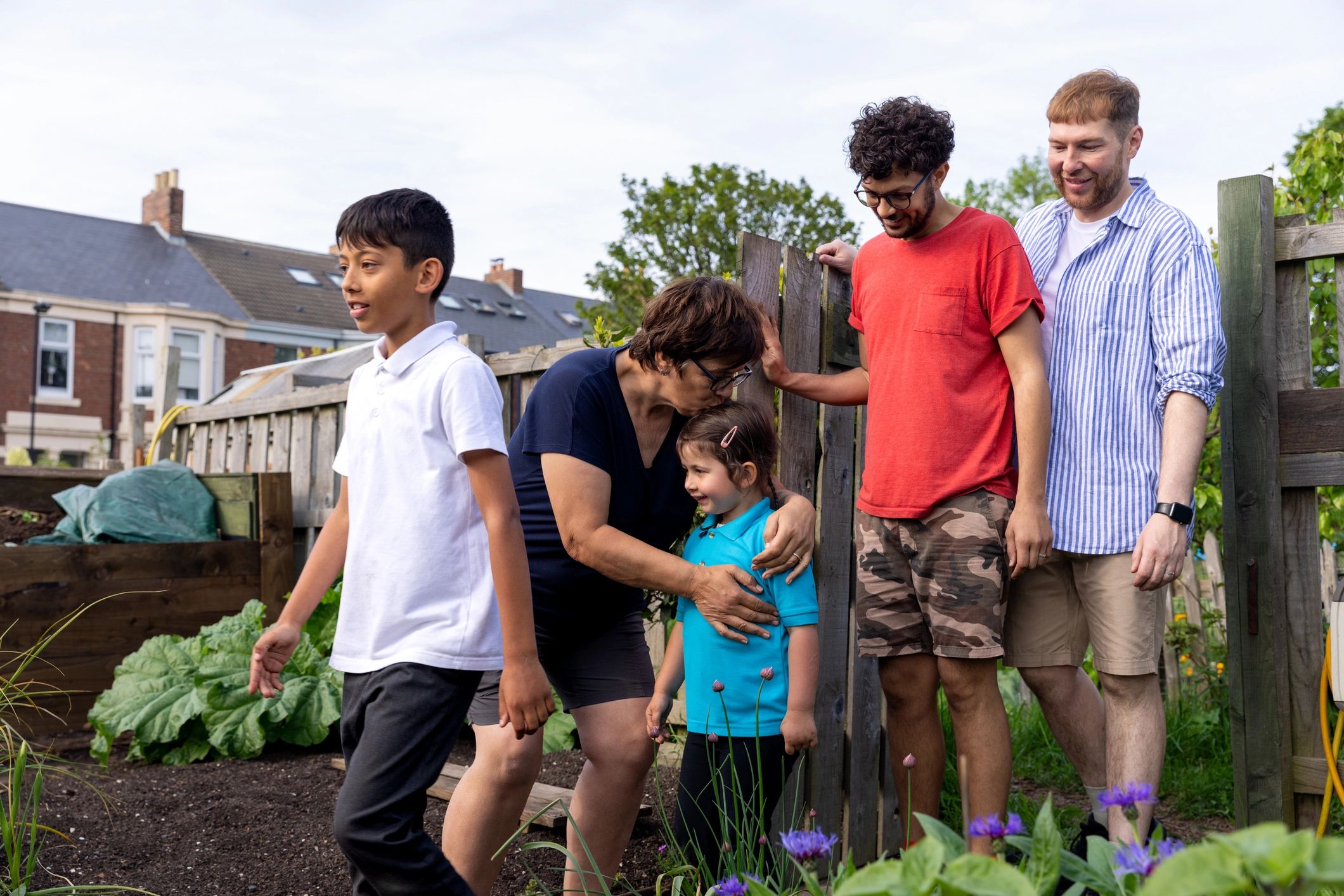 Multi-generational family arriving at a garden allotment together