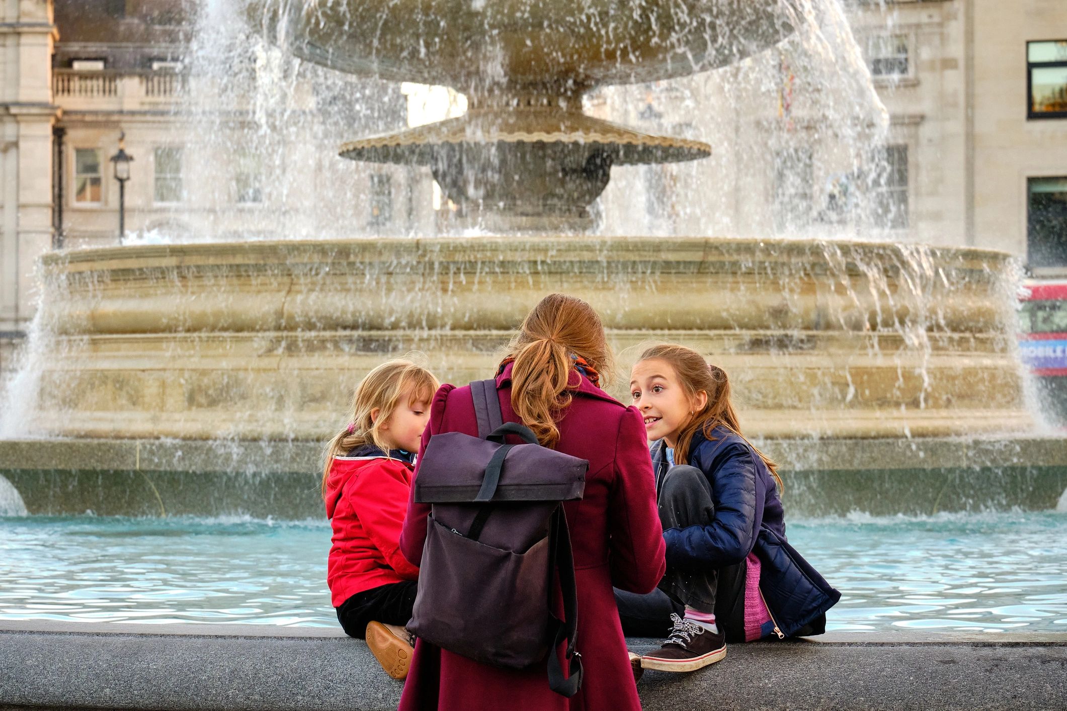 Mother and daughters sharing a heartfelt moment together outdoors