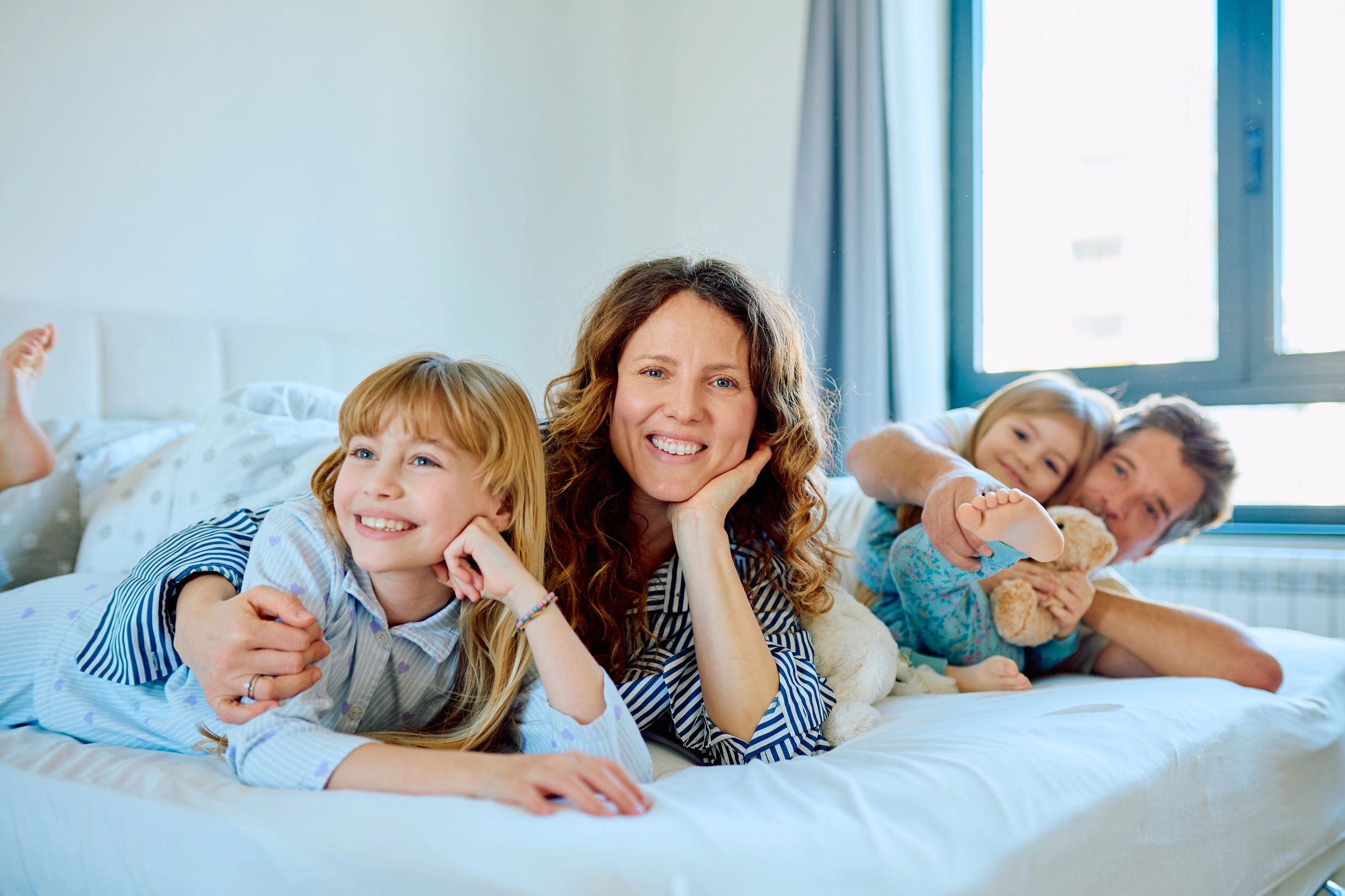 Family relaxing together in bed