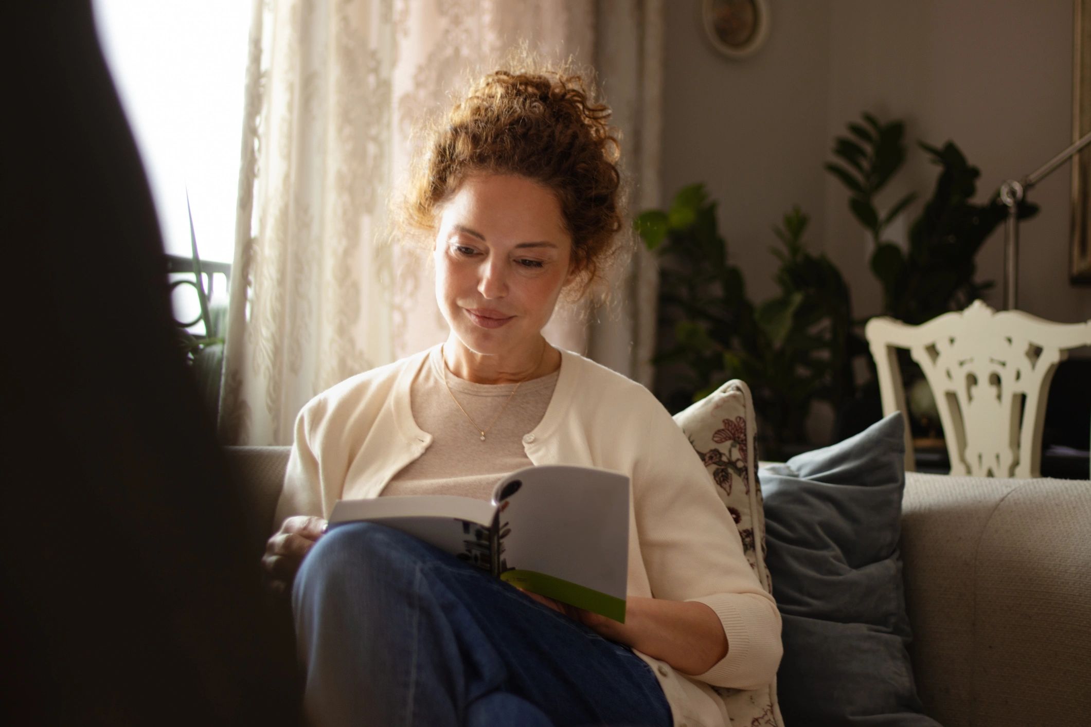 Person reading quietly with a book, representing reflective storytelling
