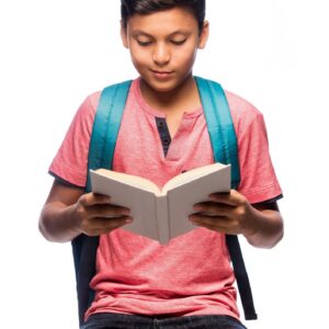 Latin schoolboy sitting and reading a book